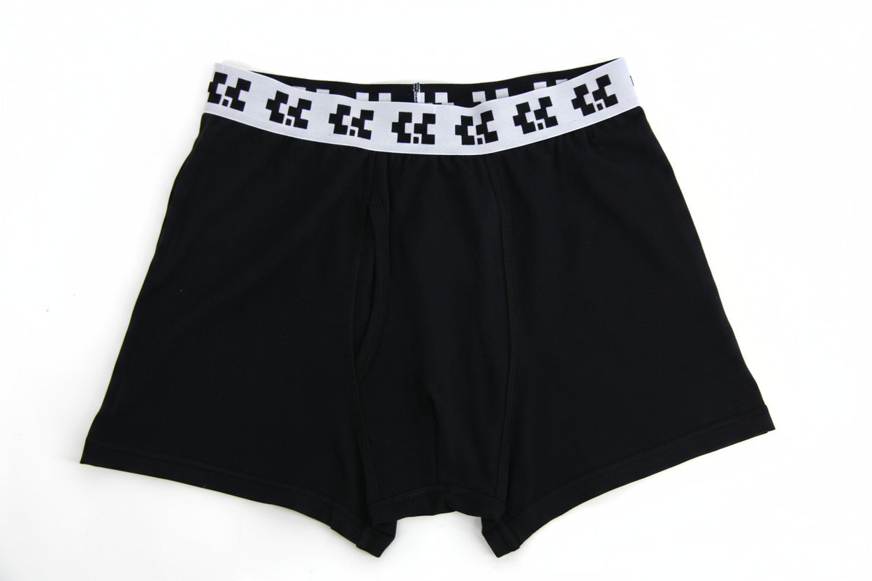 Black boxer briefs with a pixelated waistband on a white background