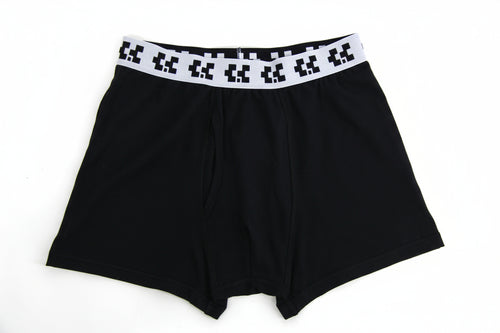 Black boxer briefs with a pixelated waistband on a white background